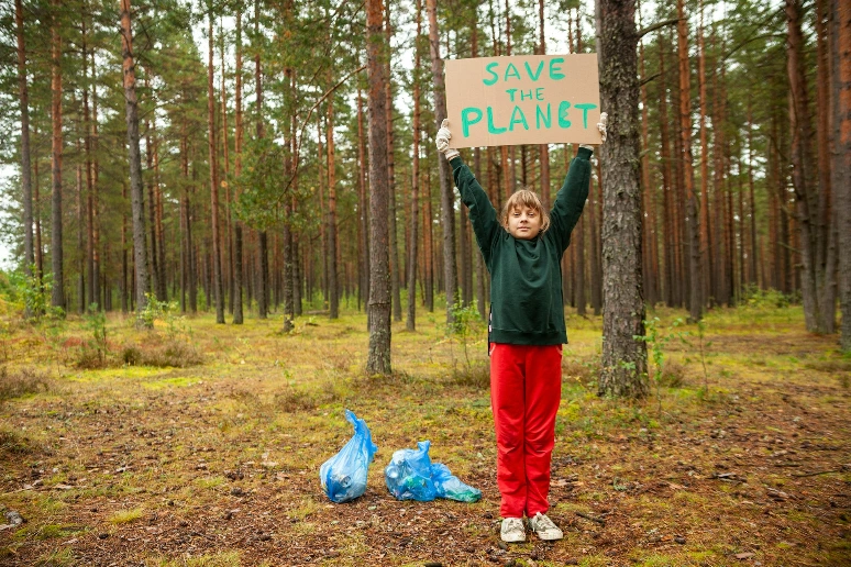 a person holding a sign in the woods